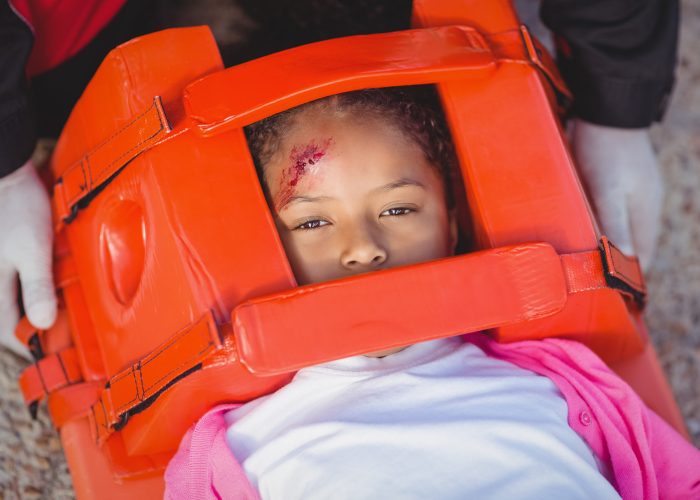 Injured girl treated by paramedic at accident spot